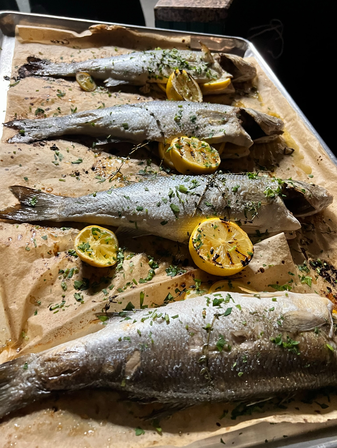 Roasted branzino with lemon and herbs on a sheet pan