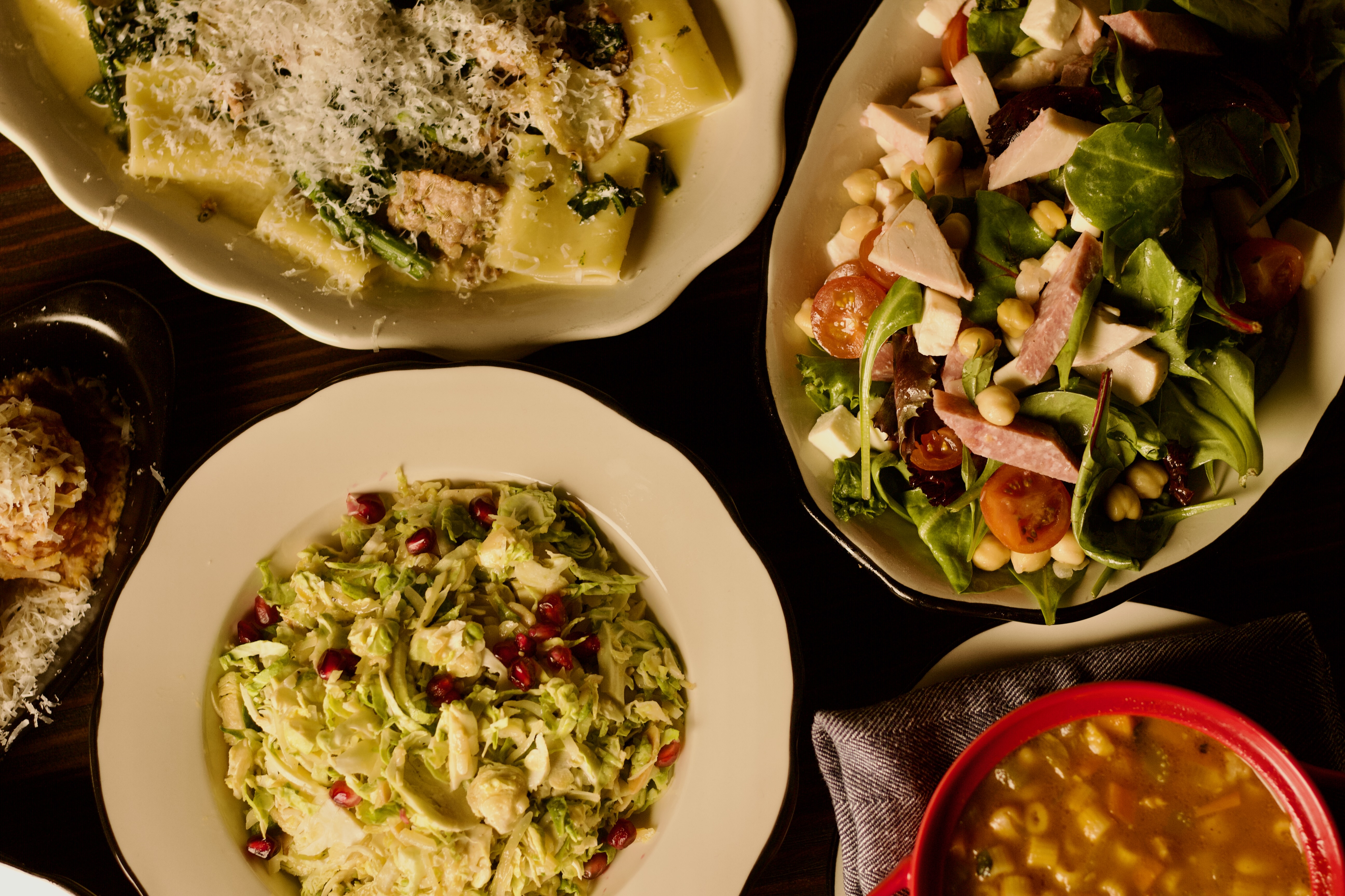 Sunday supper spread — rigatoni, salads, soup